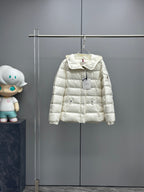 White long puffer jacket with hood and front zipper, logo tag at chest