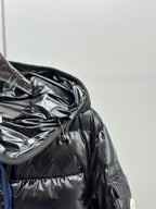 Puffer jacket chest close-up with hood drawcord and glossy quilted fabric