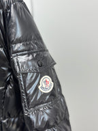 Moncler logo patch detail on glossy puffer jacket sleeve