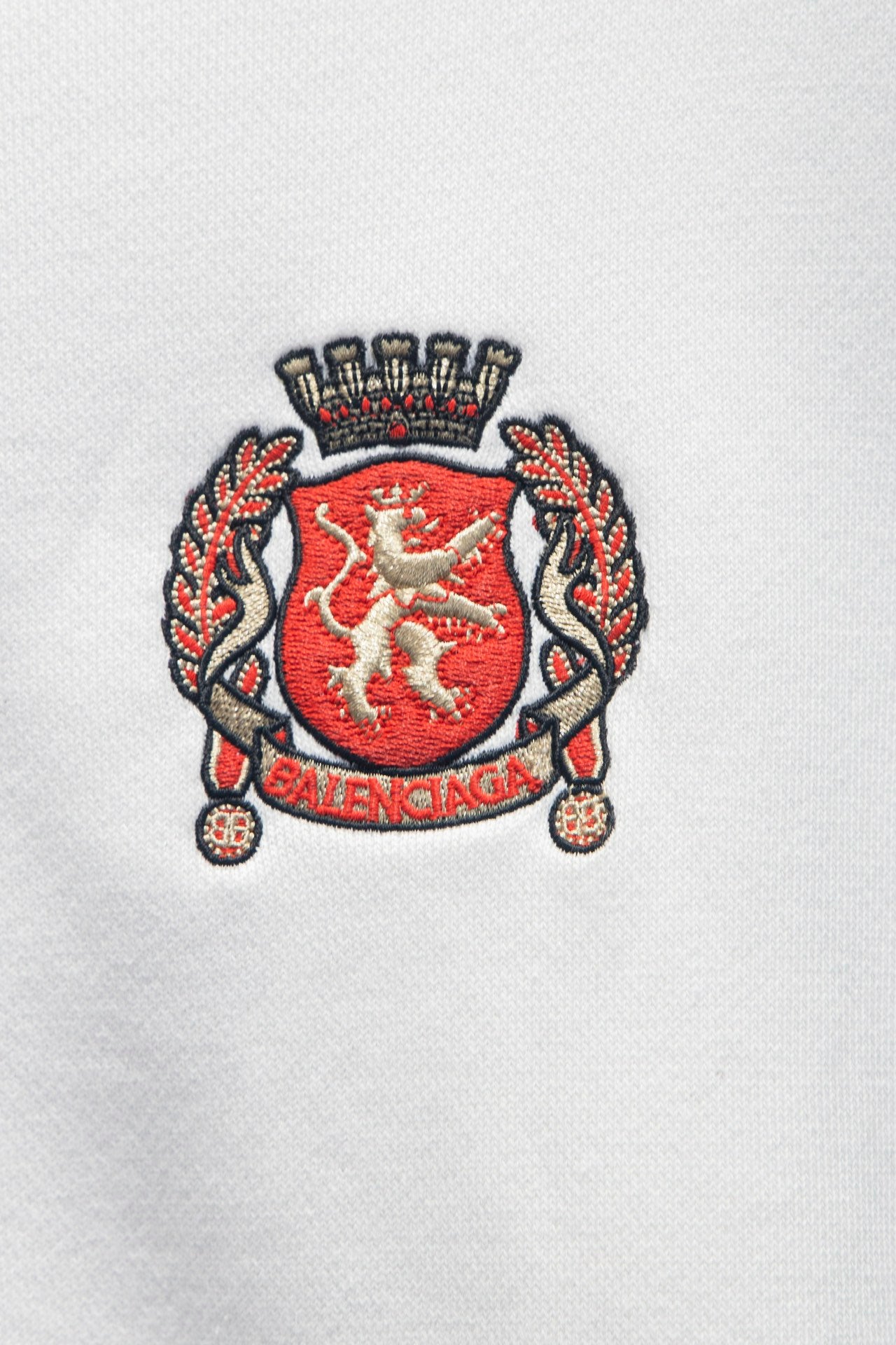 Balenciaga embroidered crest emblem on white zip-up hoodie