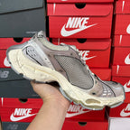 Unisex sneakers angled view with grey mesh paneling and cream midsole