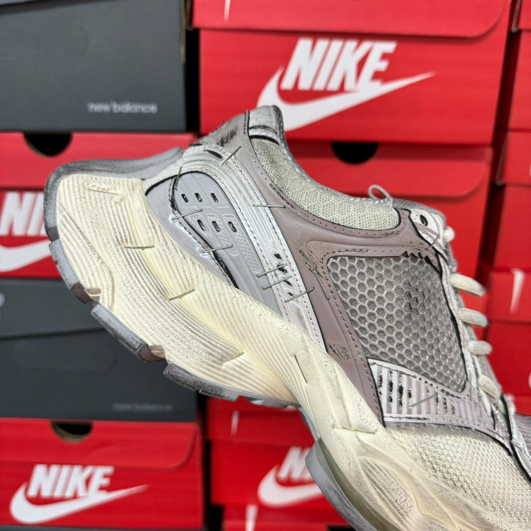 Unisex sneakers front view in grey with knit tongue, lace-up closure, and textured sole