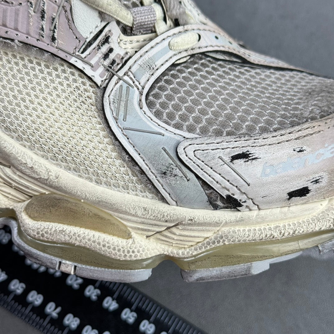 Silver sneaker side panel with logo detail and textured sole