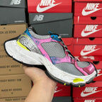 Unisex running shoe, gray mesh with pink and blue accents and thick white sole