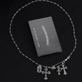 Silver-tone cross charm necklace with multiple dangling crosses on a chain