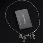 Silver-tone cross charm necklace with multiple dangling crosses on a chain