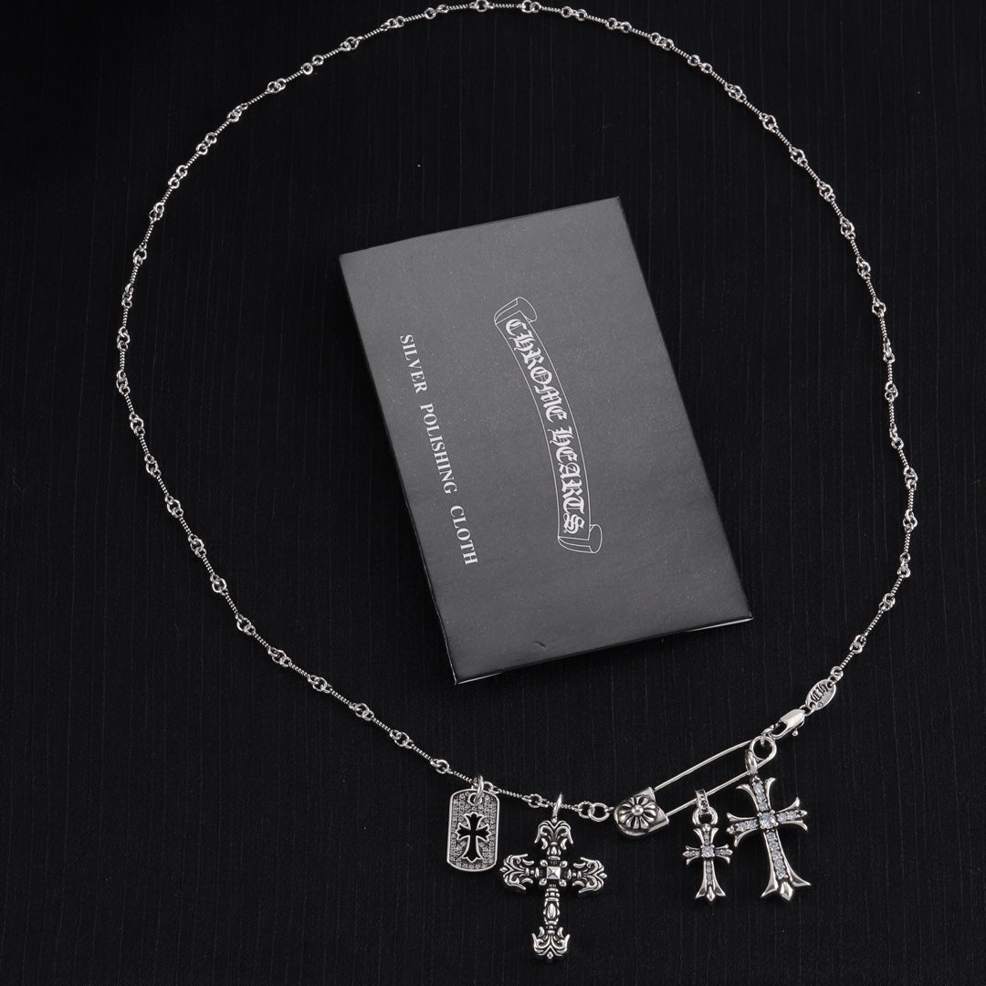 Silver-tone cross charm necklace with multiple dangling crosses on a chain