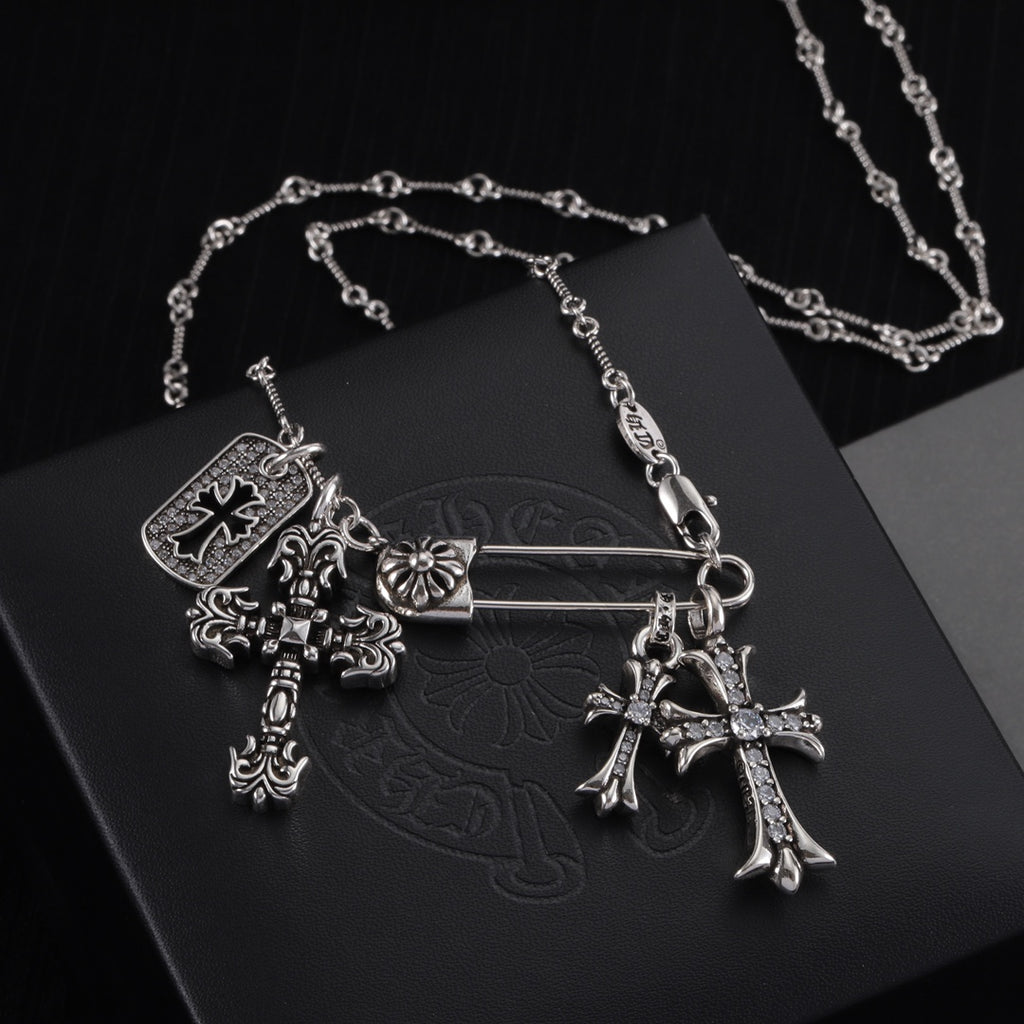 Silver-tone cross charm necklace with ornate cross pendant and rectangular tag charm