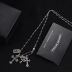 Silver-tone cross charm necklace with three cross pendants and chain links