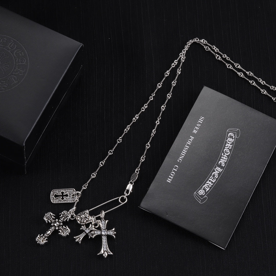 Silver-tone cross charm necklace with three cross pendants and chain links
