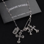 Silver-tone cross charm necklace with large cross pendant and smaller cross charms