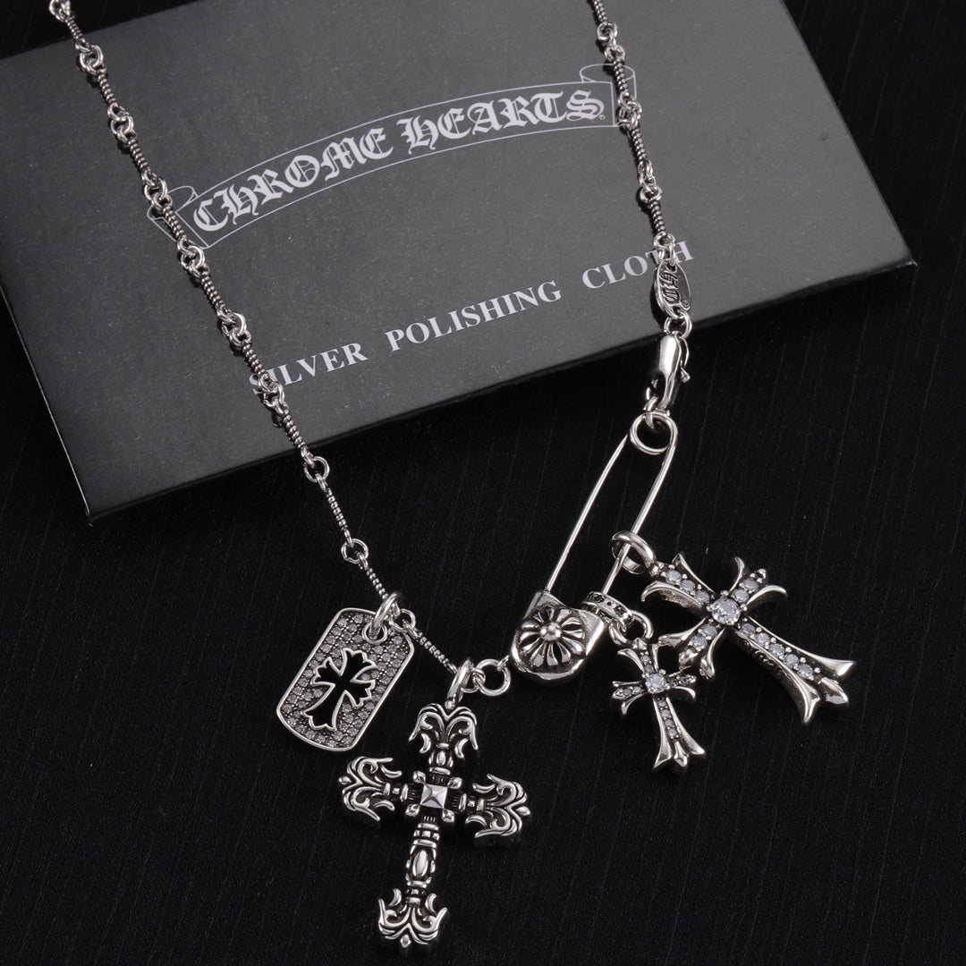 Silver-tone cross charm necklace with large cross pendant and smaller cross charms