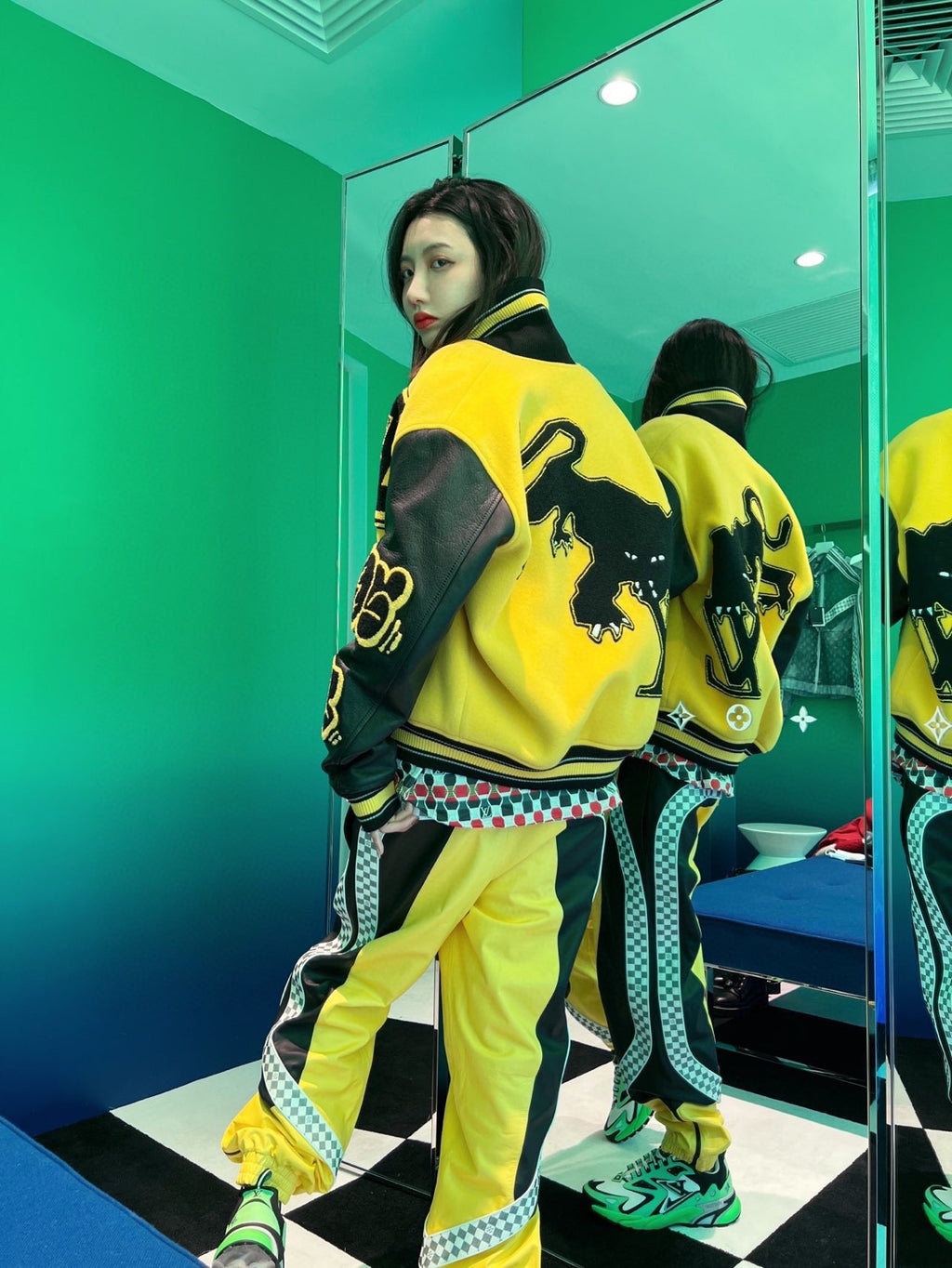 Louis Vuitton yellow varsity jacket with black sleeves, trim, and logo graphics