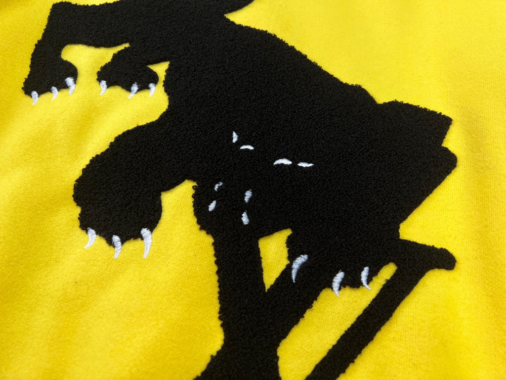 Yellow Louis Vuitton jacket with large black cowboy silhouette graphic on front