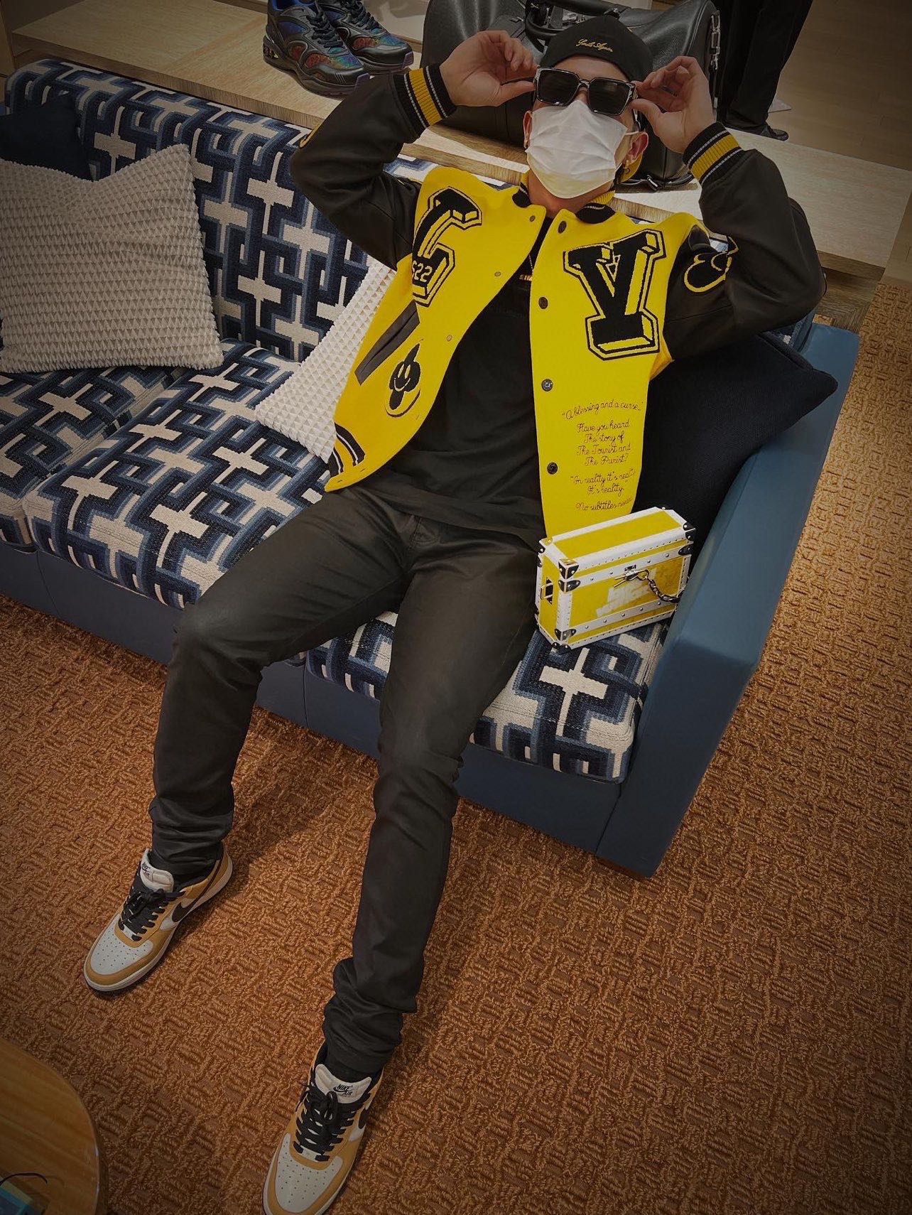 Louis Vuitton yellow varsity jacket with black accents, logo patches, and snap front