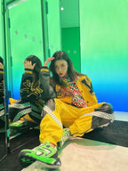 Louis Vuitton yellow varsity jacket with black trim and large LV-style back graphics