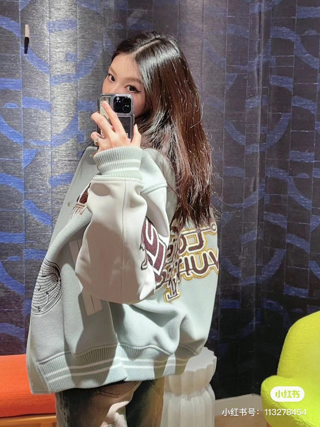 Cream/white hoodie with large graphic sleeve lettering and ribbed cuffs