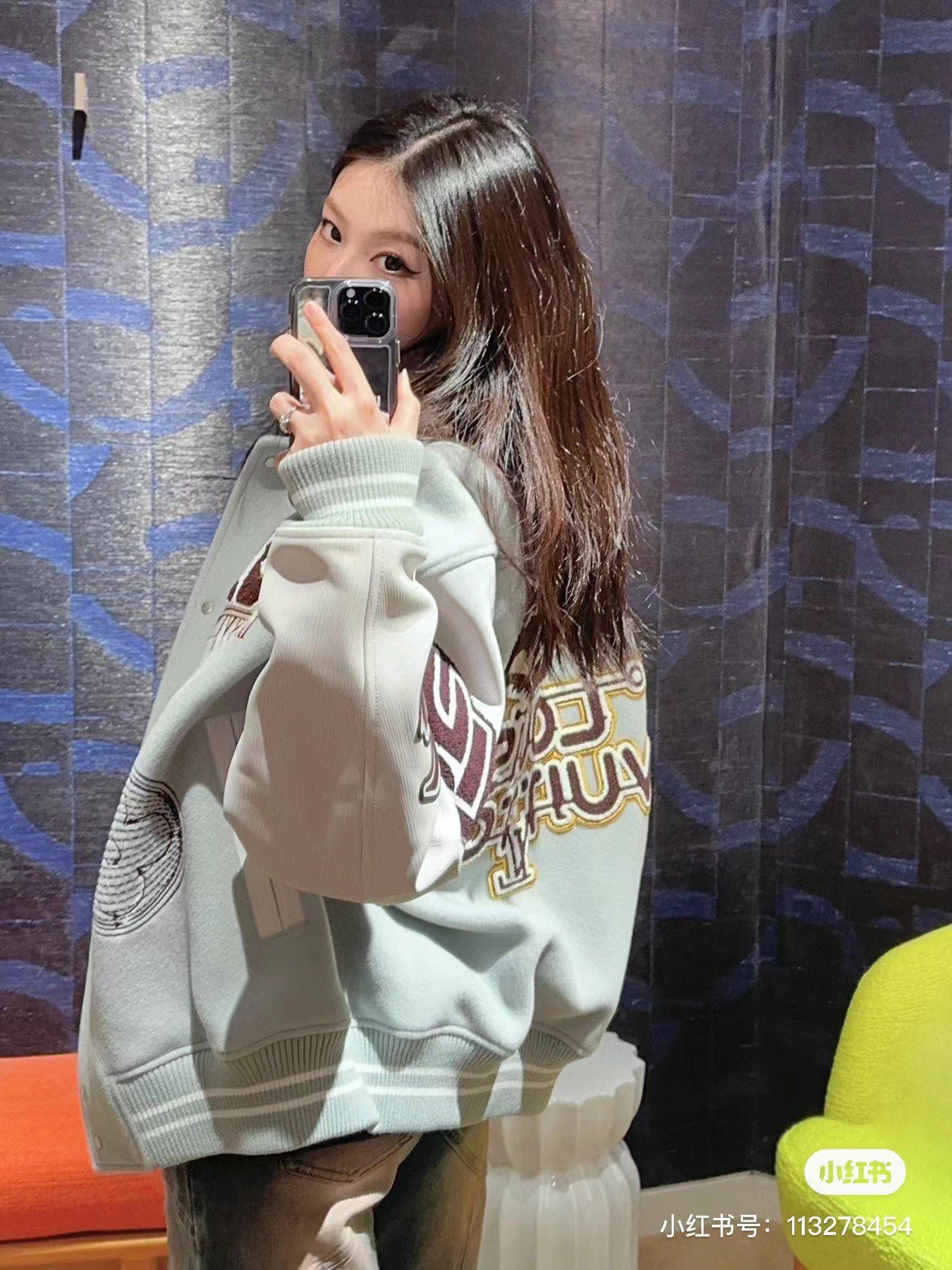 Cream/white hoodie with large graphic sleeve lettering and ribbed cuffs