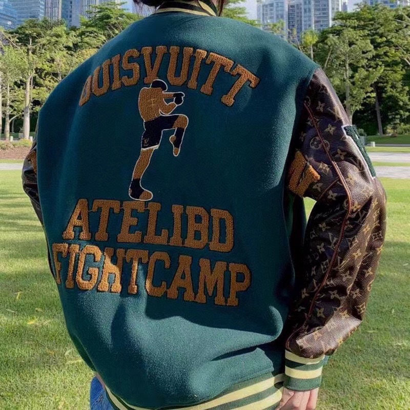 Green varsity jacket back view with large brown text and stripe trim at hem