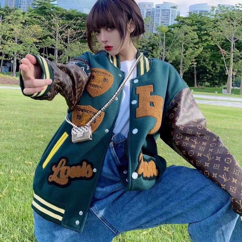 Green varsity jacket with button front, striped cuffs, and patch graphics on sleeves