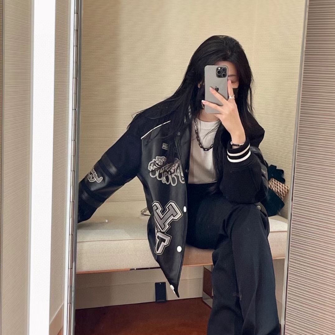 Louis Vuitton varsity jacket, black with white striped cuffs and large graphic patch on chest