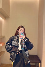 Louis Vuitton leather-look varsity jacket worn over T-shirt, front patches and striped cuffs