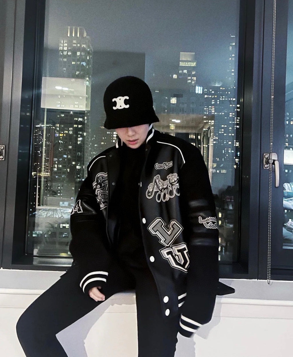 Louis Vuitton long varsity jacket, black with white striped cuffs and logo graphics