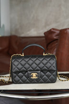 Chanel quilted black mini handbag with gold chain and CC clasp