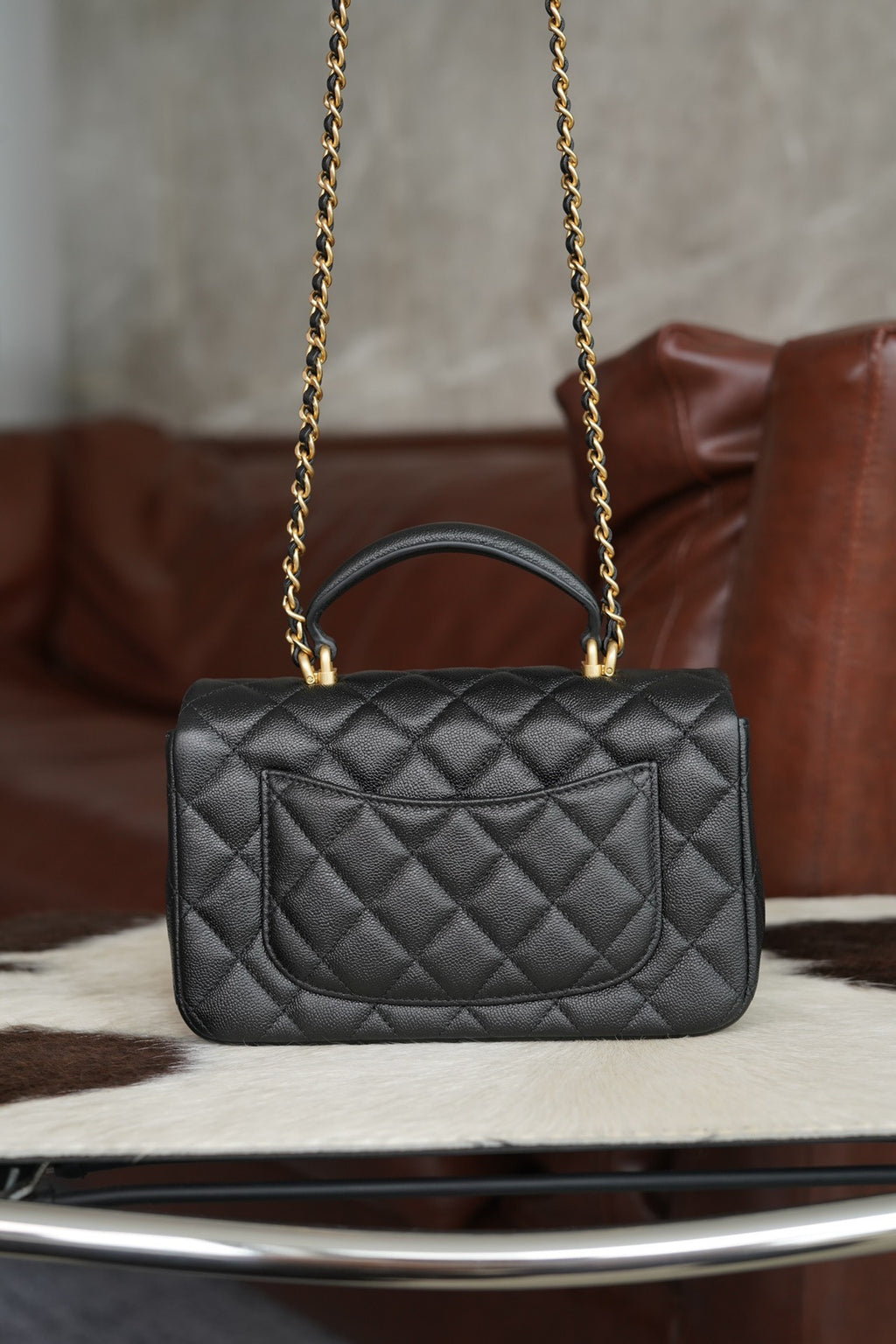 Chanel quilted black flap crossbody bag with gold chain and top handle