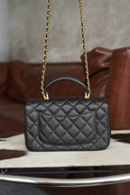 Chanel quilted black flap crossbody bag with gold chain and top handle