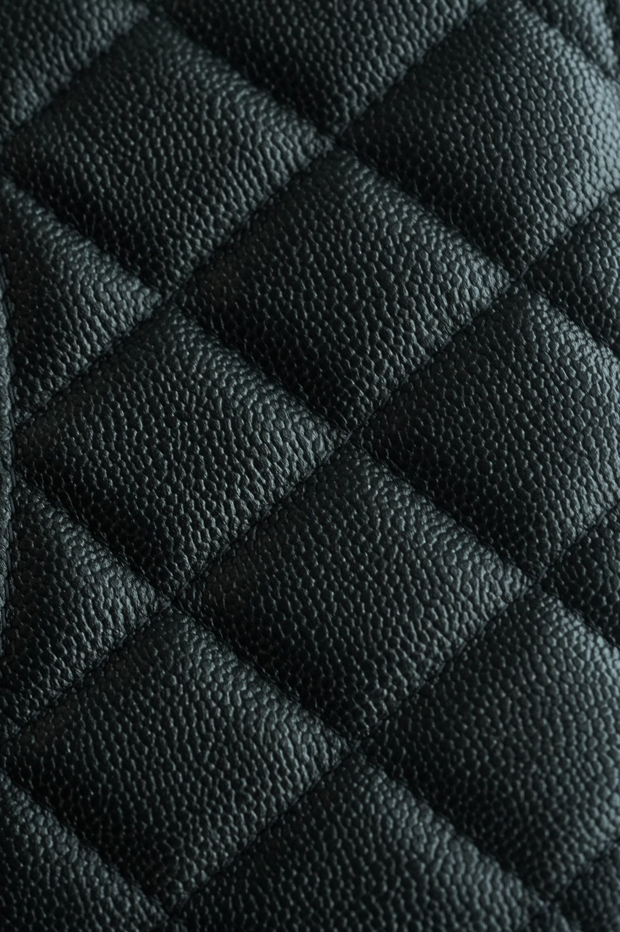 Chanel quilted black leather pattern close-up with diamond stitching