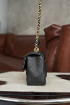 Chanel quilted black mini bag with gold chain strap and side detail