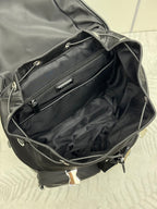 Prada black nylon tote-style bag open, showing interior lining and zipper