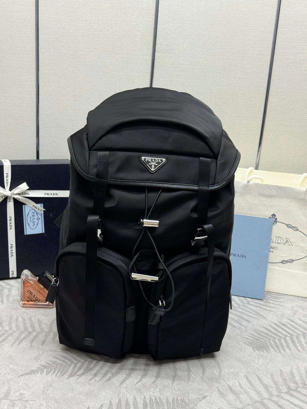 Prada black nylon backpack with top flap and triangular logo patch