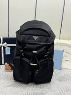 Prada black nylon backpack with top flap and triangular logo patch