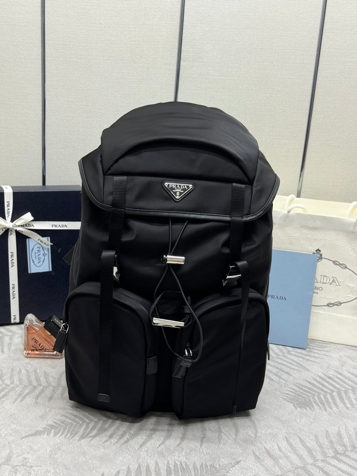 Prada black nylon backpack with top flap and triangular logo patch