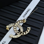 Gold-tone chain bracelet with interlocking C pendant and rhinestone detailing