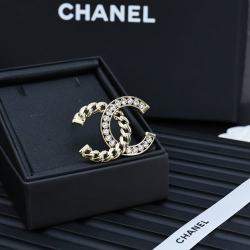 Gold-tone chain bracelet with interlocking C and clear rhinestone border