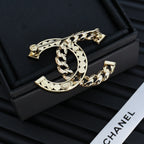 Gold-tone chain bracelet with rhinestone interlocking C and scalloped trim