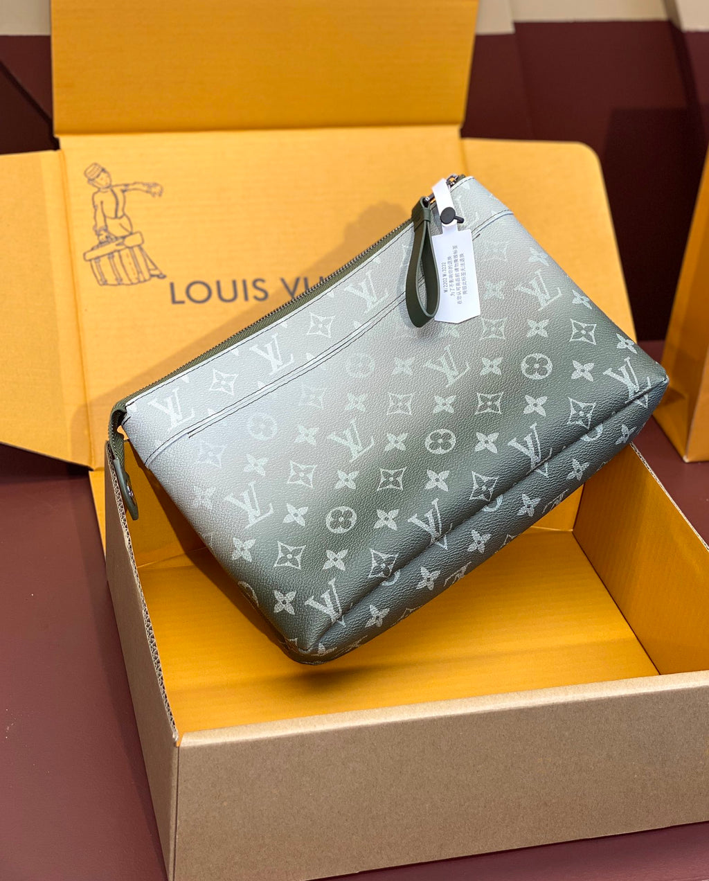 Louis Vuitton monogram wristlet bag, light blue-gray, top zipper and angled view