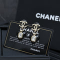 Chanel earrings with silver CC details and black heart charm with clear crystal drop