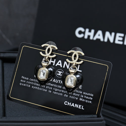 Chanel earrings with silver CC details and black heart charm with clear crystal drop