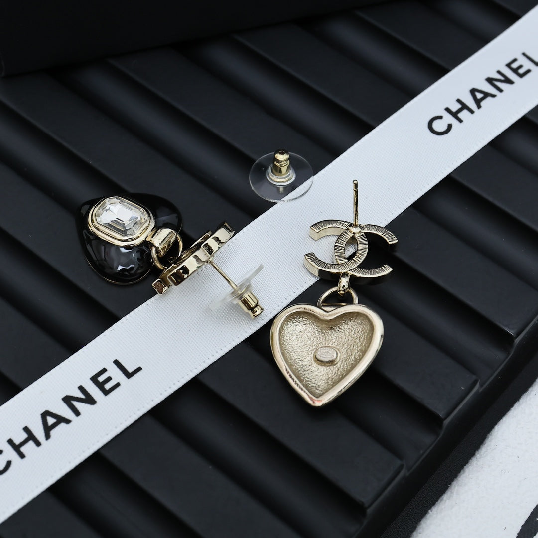 Chanel earrings with black heart charm, clear crystal, and silver CC accents