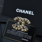 Chanel jeweled CC-style brooch with gold-tone metal and clear crystal accents