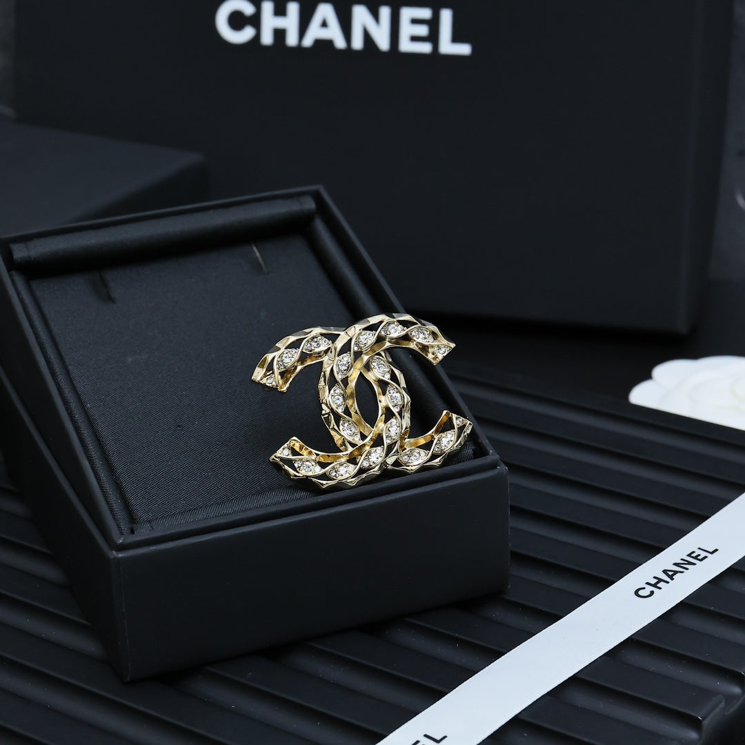 Chanel jeweled CC-style brooch with gold-tone metal and clear crystal details