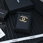 Chanel CC-style crystal brooch in a black presentation box