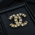 Chanel jeweled CC-style brooch with gold-tone settings and clear crystals