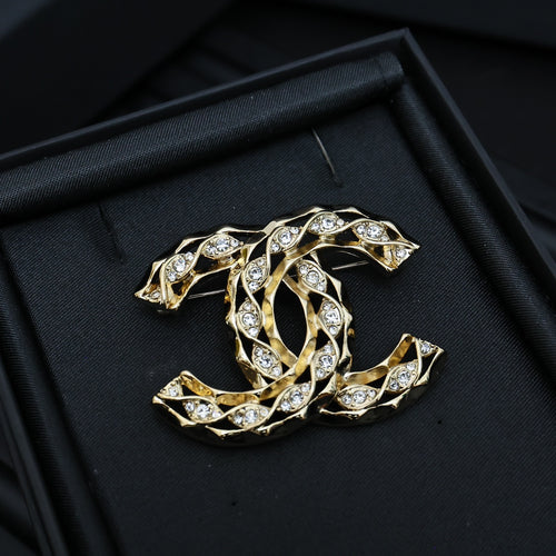 Chanel jeweled CC-style brooch with gold-tone settings and clear crystals