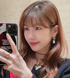 Chanel heart drop earrings with CC charm and crystal center, worn