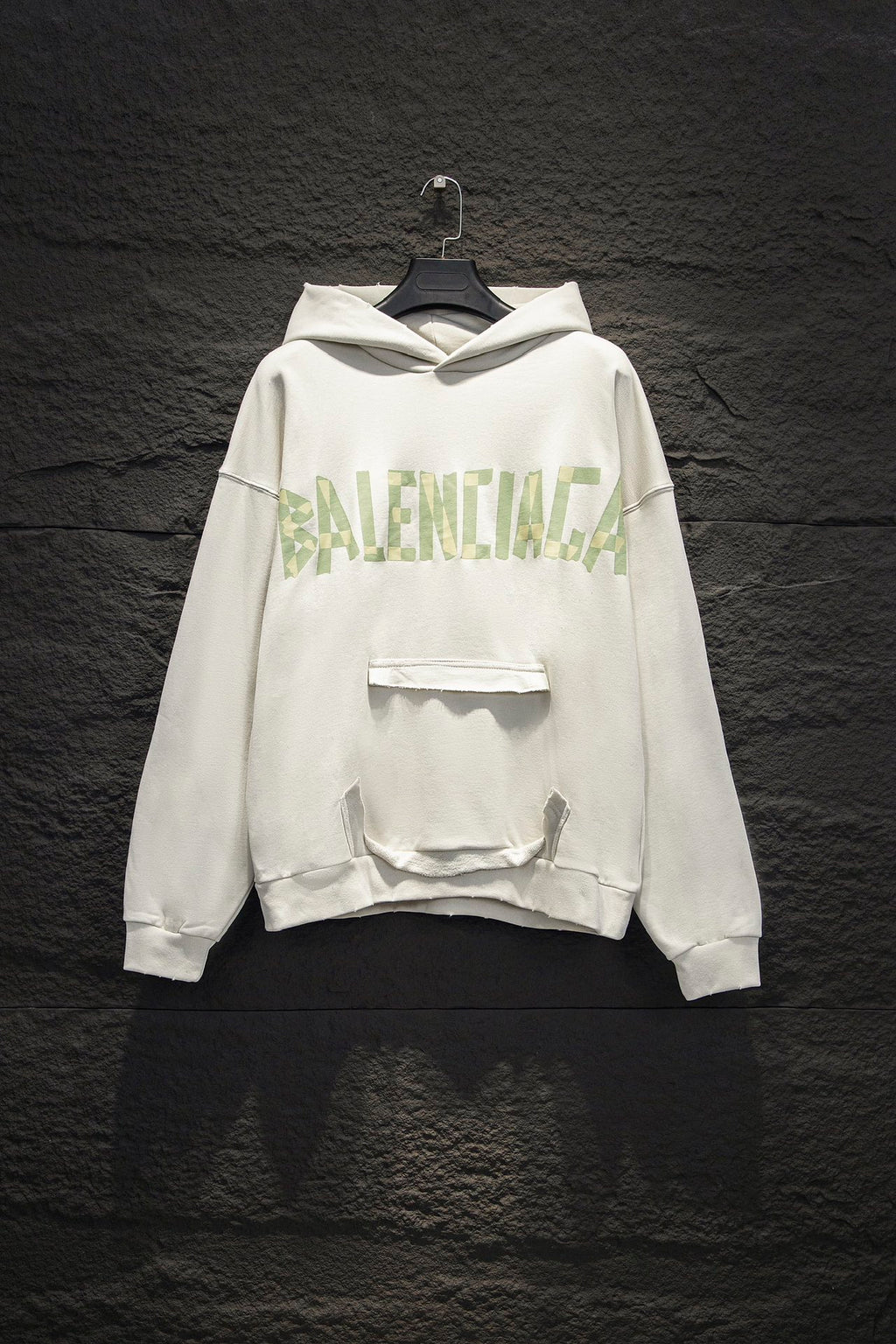 Off-white hoodie with hood, front logo print, and kangaroo pocket